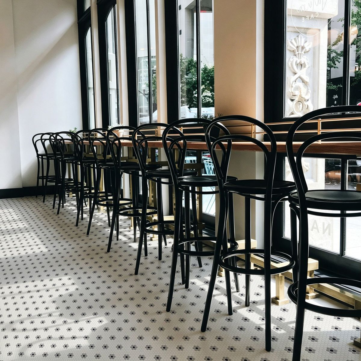 Avora Coco Haven recycled glass hexagon mosaic floor with a flower pattern in a cafe